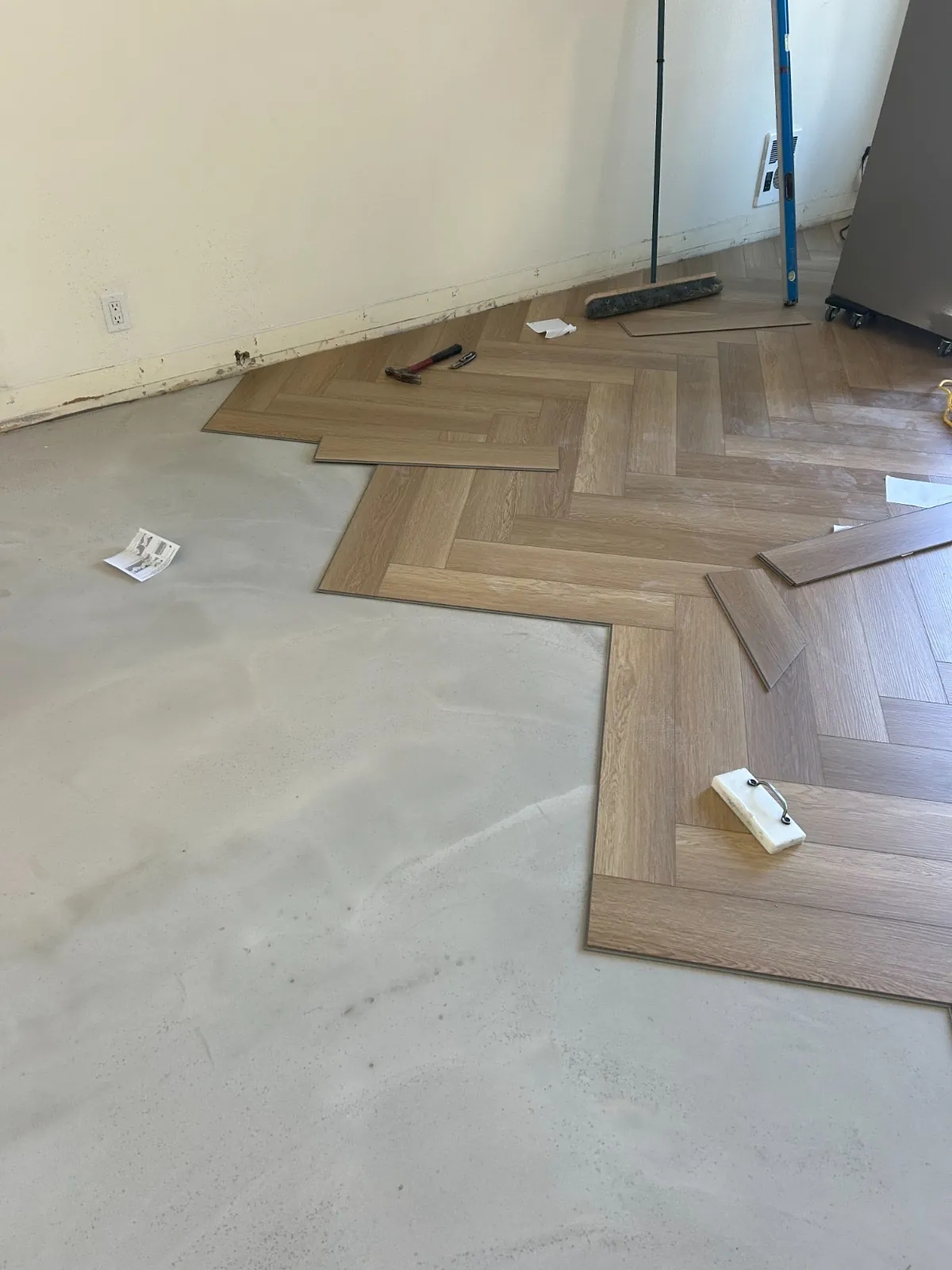 Herringbone planks being laid over the prepared base