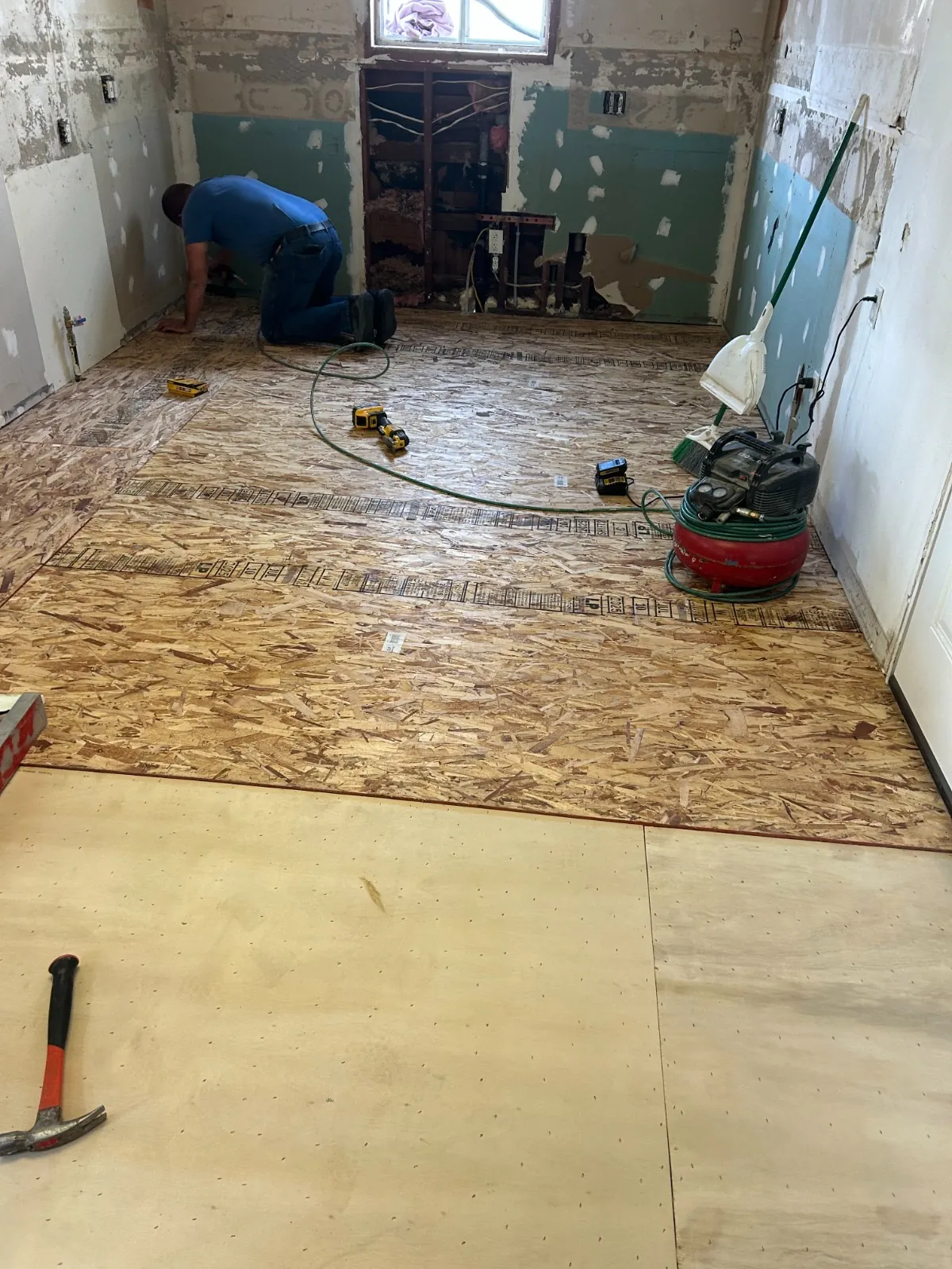 Craftsman working on the exposed subfloor