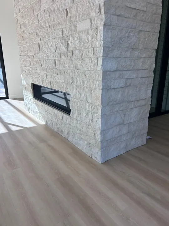 Plank detail beside the stone fireplace